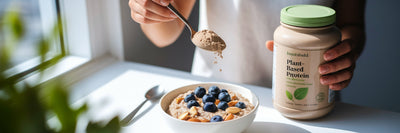 Person adding vegan protein to oatmeal.