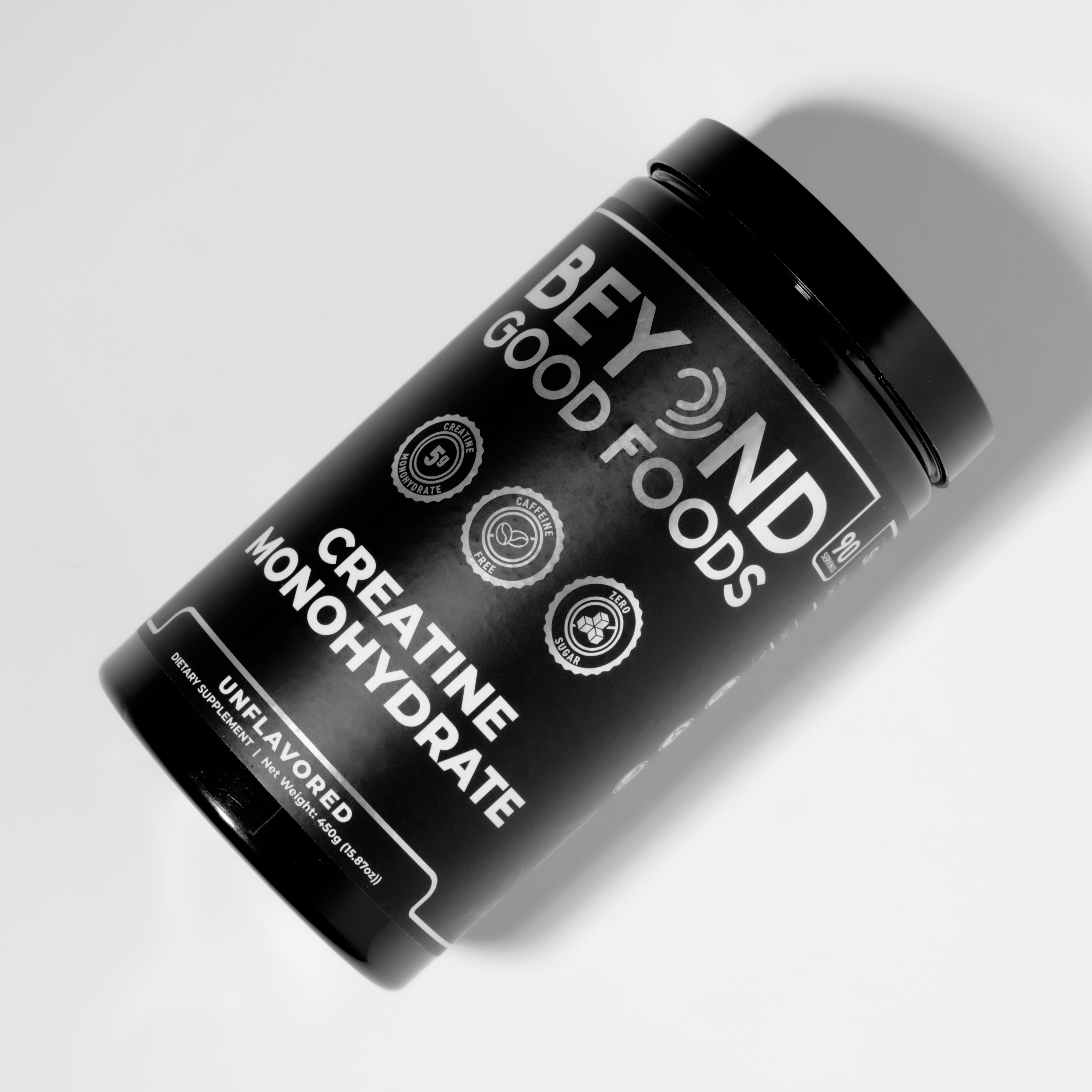 Black Creatine Monohydrate container labeled Beyond Good Foods on a white background