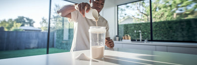 Person making a vegan protein and creatine shake.