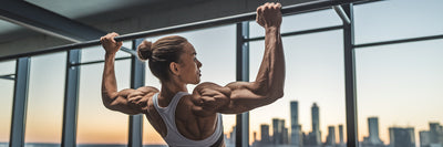 Athlete performing pull-ups in gym.