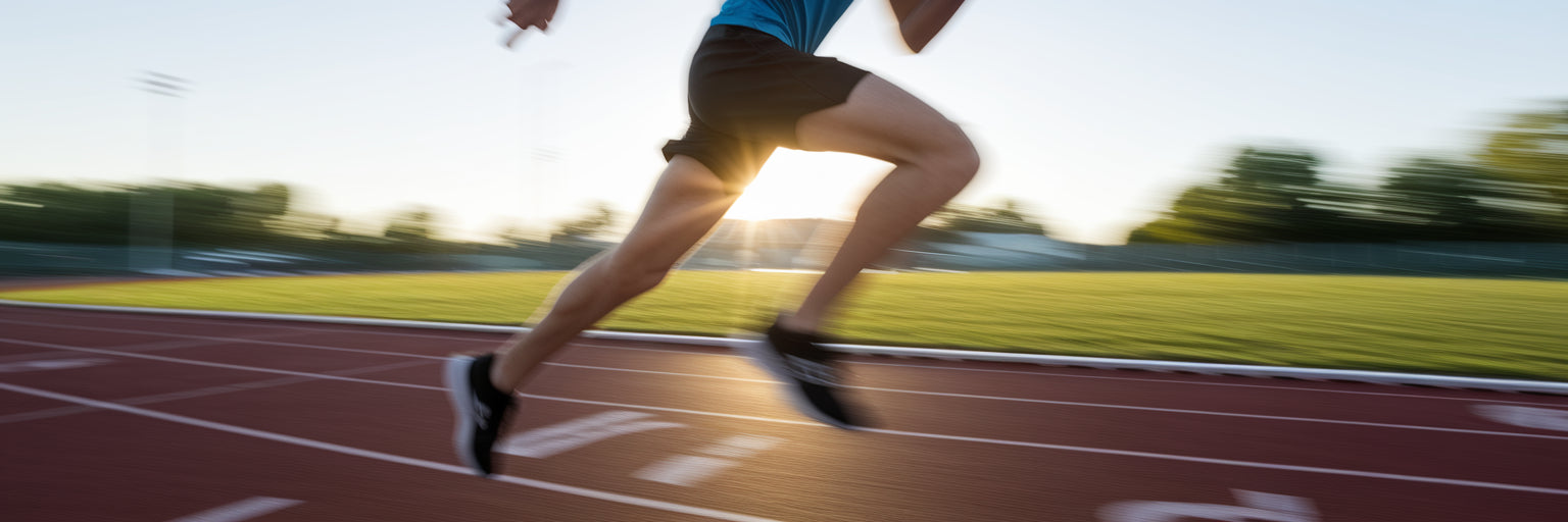 Teen athlete running on a track.