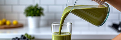 Pouring a green vegan post-workout smoothie