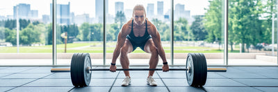 Vegan athlete performing a powerful deadlift.