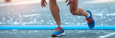 Marathon runner stretching after a race.