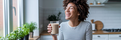 Person enjoying a vegan protein smoothie.