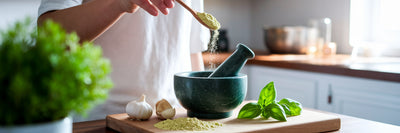 Adding unflavored protein to homemade pesto.