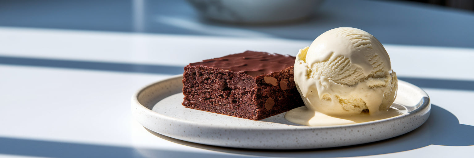 Slice of vegan protein brownie with ice cream.