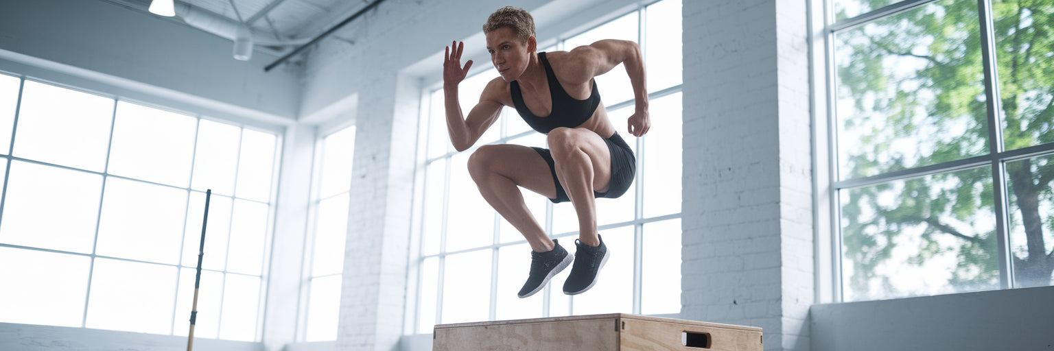 Athlete performing box jump during HIIT.