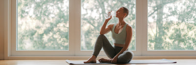 Person recovering after yoga with protein shake.