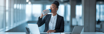 Professional managing stress with a protein shake.