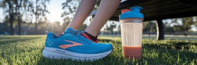 Running shoes and protein shake after run.