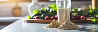 Vegan protein and creatine powders on kitchen counter.