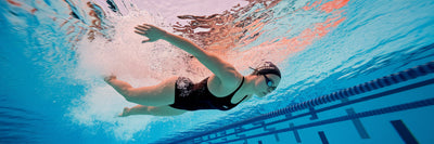 Competitive swimmer in motion underwater.