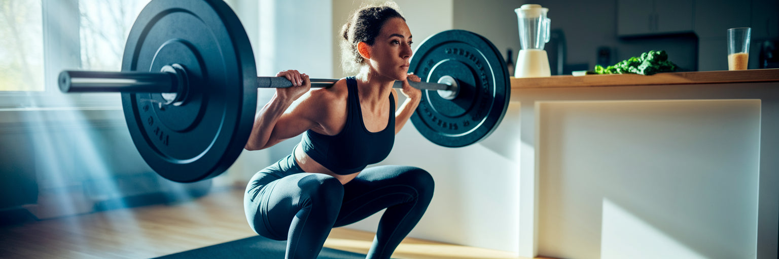 Person performing a barbell squat.