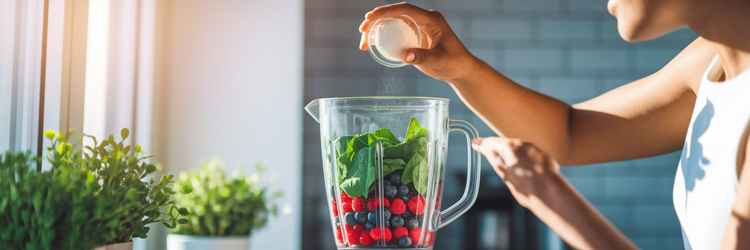 Person adding vegan protein powder to a blender.