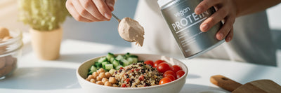 Adding vegan protein to meal prep bowl.