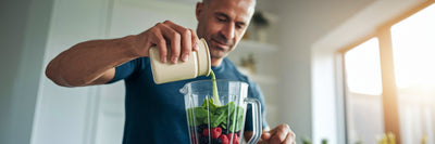Man in his 40s making a healthy vegan protein smoothie.