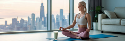 Woman practicing yoga with protein shake.
