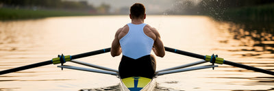 Rower finishing a powerful stroke on water.
