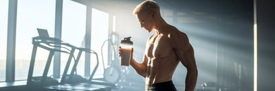 Athlete holding protein shaker after workout.